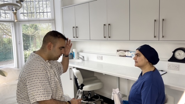 Patient discussing their hair restoration treatment with member of the team